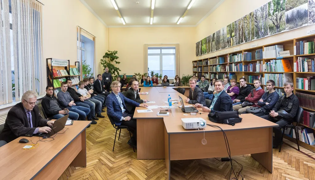 Reading room of a scientific library with wooden tables and bookshelves